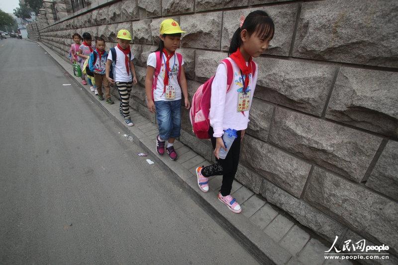 2013年09月11日，濟南運署街上，小學生走史上“最窄人行道”上學。圖片來源：CFP