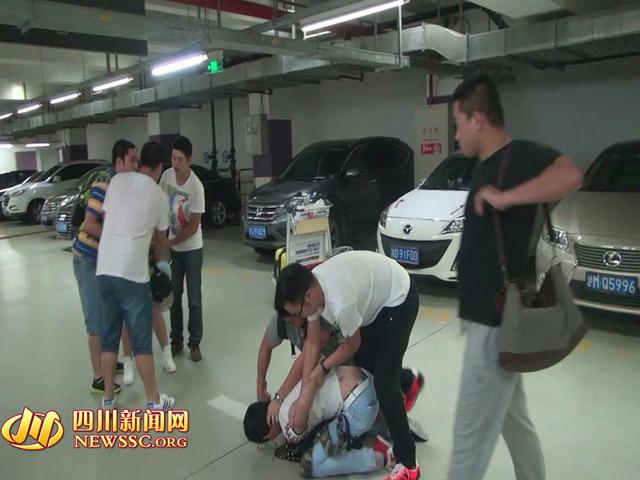 辦案人員在機(jī)場(chǎng)停車場(chǎng)抓獲胡某及其女友（警方視頻截圖）。