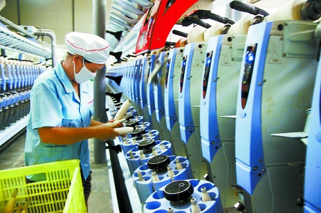 7月3日，在鄧州市永泰棉紡有限公司電腦控制全自動(dòng)紡紗車(chē)間，紡織工人正在生產(chǎn)棉紗。