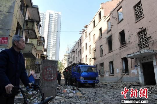 一位花甲老人站在即將拆除的樓房旁，默默地與“蘇聯(lián)樓”告別。　翟羽佳　攝